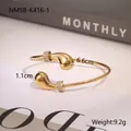 Detail view of gold open bangle with pearl accents showing 6.6cm inner diameter and weight - Gold Teardrop Style