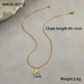 Detailed close-up of a gold whale tail pendant with 45+5cm stainless steel chain - 18K Gold / Mermaid Tail Necklace