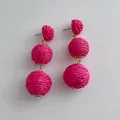 Handmade fuchsia raffia ball drop earrings with three-tier woven spheres and golden accents - Rose Red