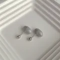 Macro shot of minimalist marble texture stud earrings with silver metal base detail - Gray