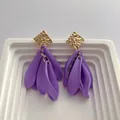 Retro purple petal fringe earrings with gold geometric stud on white ceramic display - Purple