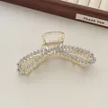 Close-up of a gold metal hair claw clip with double-layered bow design and sparkling zircons - Gold Figure-Eight Cross Zirconia Style (R13)