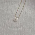 Detail of a natural shell letter I pendant on a golden snake chain necklace - Letter I Pendant Necklace