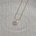 Macro view of a gold snake chain necklace with a shell pendant featuring a cursive Y - Letter Y Pendant Necklace