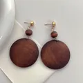 Chic oversized circular wood drop earrings with natural brown grain and gold metal studs - Dark Brown