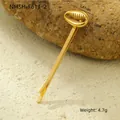 Detailed view of a gold shell-shaped hair clip with pearls on natural rock background - Conch Style (NMSH-F611-2)