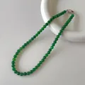Macro detail of natural green chalcedony beads and silver buckle on a ceramic plate - Beaded Necklace (V-27) / 6mm / Green