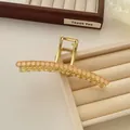 Detail of golden metal hair claw clip with pink resin beads on a velvet jewelry tray - Orange Pink