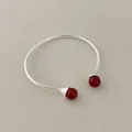 Detailed close-up of open cuff bracelet with red agate beads on textured fabric - Red Agate Bracelet
