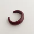 Close-up of a minimalist burgundy red resin open cuff bangle with a glossy finish - Cuff Bracelet / Ancorra Red