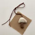Macro detail of fabric mushroom pendant with delicate lace trim and pearl accents - Off-White Lace Mushroom (T36)
