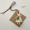 Detail of plush bunny pendant wearing lace dress with wooden button and leather cord - Beige 3D Rabbit (T52)