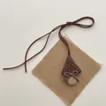 Detail of handmade mushroom plush pendant with brown fabric cap and corduroy stem - Bowknot Mushroom (T38)