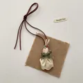 Detail of handmade rabbit doll pendant in lace dress with brown leather strap - Beige Lace Dress Rabbit (T07)