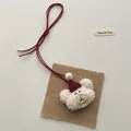 Detail of soft cream plush bear keychain with red Christmas hat on linen background - Bear with Red Hat (T62)