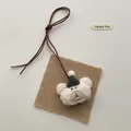 Detail of cute teddy bear plush charm with party hat and brown suede lanyard - Bear with Green Hat (T63)