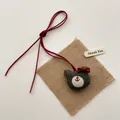 Detail of a handmade green checkered fabric bear charm with red bow and Thank You tag - Green Grid Bear
