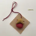 Close-up of a plush fabric star pendant with a red suede bow and handmade texture - Orange Starfish (T09)
