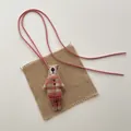 Detailed view of handmade fabric bear pendant with red check shirt and leather strap - Red Plaid Outfit Bear