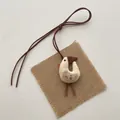 Detailed view of handmade linen duck pendant with floral wing pattern and brown suede cord - Long Legged Chicken with Brown Hat (T03)