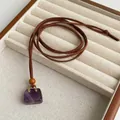 Detail view of square purple amethyst pendant on a brown faux suede long necklace - Amethyst Style