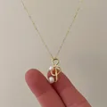 Detail of a gold treble clef pendant featuring elegant white pearls on a delicate chain - Gold Music Note Pearl Necklace