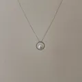 Detail of silver chain necklace with a diamond-encrusted circular pendant and white pearl - Silver Hollow Circle Pearl Necklace