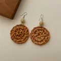 Detailed close-up of handmade woven rattan earrings with cream beads and silver hooks - Brown Rattan Dreamcatcher (B353)