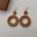 Detail of bohemian handmade rattan woven earrings with orange wood beads and silver hooks - Rattan Circle Dark Brown (B348)