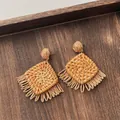 Detail shot of handcrafted bohemian raffia earrings with natural textures and long fringes - Hollow Rhombus Tassel Wood Color (A309)