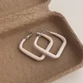 Detailed view of square cream enamel hoop earrings with a matte geometric texture - Square Small / Off White