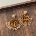 Macro detail of natural wooden beads and hand-woven raffia fan fringe earrings - Wood Bead Fan Shape Tassel Wood Color (A301)
