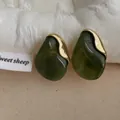 Macro view of dark green resin earrings with gold flecks and metallic border detail - Army Green