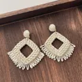 Close-up of bohemian raffia woven earrings with diamond shape and fringe detail - Hollow Rhombus Tassel Beige (A305)