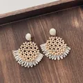 Close-up of handmade raffia earrings with peach beads and woven fringe details - Bead Fan Shape Tassel Pale Orange (A301)