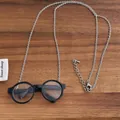 Detail view of retro black round glasses pendant with a fine silver lobster clasp chain - Black Glasses Style (P-153)