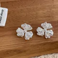 Detailed close-up of zircon flower earrings with silver brushed metal finish - Three-petal Flower Shape (Silver)