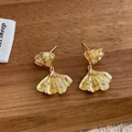 Detailed macro shot of golden ginkgo leaf earrings with zircon crystals on wood - Double Layer Gingko Leaf Shape (Gold)