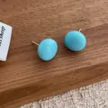 Glossy light blue round stud earrings with minimalist design and polished finish - Blue
