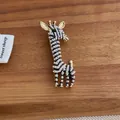 Close-up of giraffe brooch featuring gold metal base and white pearl inlay detail - Black Giraffe Style (M-199)