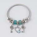 Macro shot of silver-toned spring bracelet with blue beads and heart butterfly pendant - Silver Light Blue Heart Butterfly Style (22)