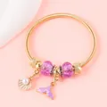 Detail of gold spring bracelet with purple beads and white shell pendant charms - Gold Purple Fishtail Shell Style (15)