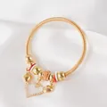 Detail of gold spring bracelet with orange crystal beads and heart-shaped pendants - Gold Orange Rhinestone Triple Heart Style (14)