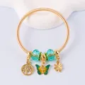 Detail of golden charm bracelet with enamel butterfly, tree of life, and lucky clover pendants - Gold Lake Blue Butterfly Clover Style (12)