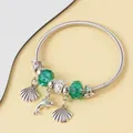 Detailed shot of ocean-themed silver charm bracelet with green beads and dolphin charms - Silver Emerald Dolphin Shell Style (8)