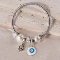 Detailed view of silver spring bracelet with evil eye charm, starfish, and pearls - Silver Evil Eye Daisy Style (5)