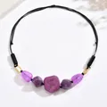 Detail of vintage beaded necklace with purple marble texture beads and golden rings - Purple