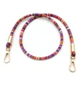 Dettaglio della tracolla intrecciata colorata con moschettoni in metallo dorato - 80 cm / Arancione viola con fibbia dorata