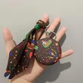 Portachiavi specchio in pelle monogram marrone con stampa colorata e sciarpa decorativa - Circo Marrone