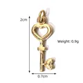 Golden heart-shaped key pendant charm in stainless steel measuring 2cm by 0.7cm - Heart Key Polished Pendant (BXGPJ194)